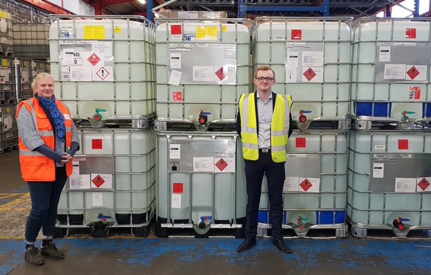 Aista Jukneviciute of Penderyn, with Jarl Hobbs of Lovair in front of IBCs of sanitizing liquid.