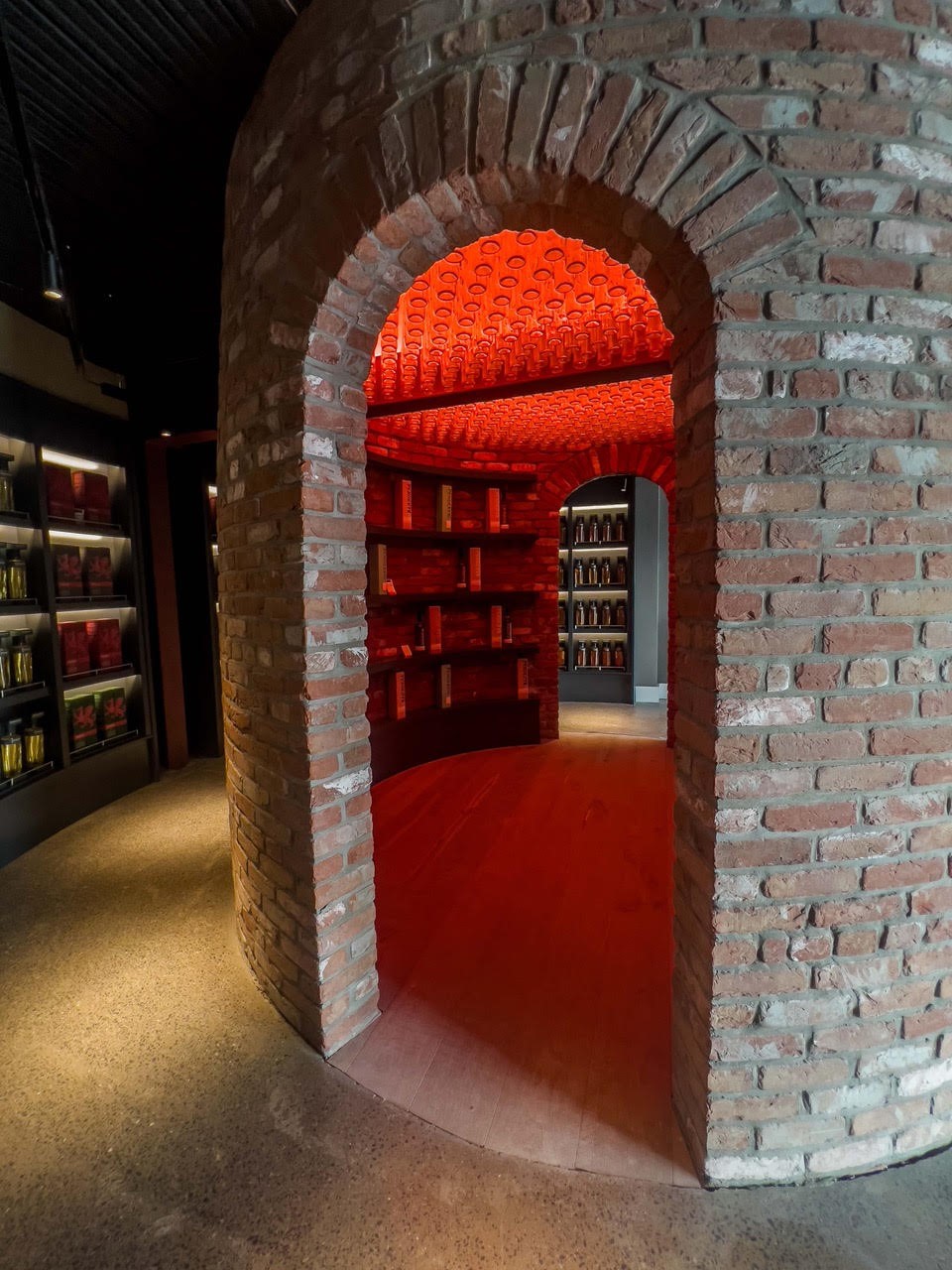 Swansea Distillery inside the shop, showcasing the centre wall space whisky display